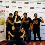PAAFF 2014 Volunteers posing in front of the step and repeat