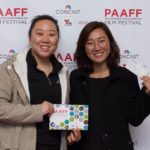 Guests holding PAAFF 2016 program book and ticket
