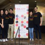 PAAFF 2016 volunteers posing with a banner