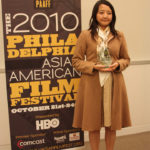 Nodoka Kato holding her trophy for Best Short Film for Frog in the Well