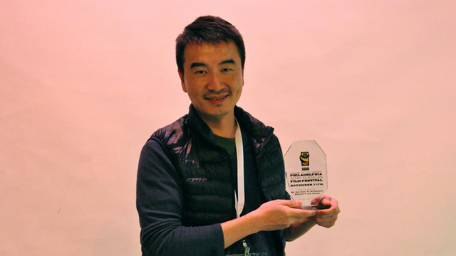 Photo of S. Leo Chiang holding his Best Documentary Feature award trophy at PAAFF 2012