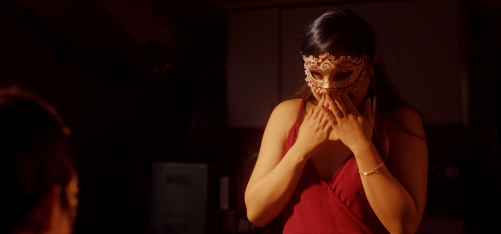 Woman touching mask on her face with both hands in from Son of Paper's "7 O'Clock" Music Video