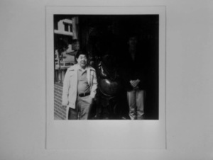 A Polaroid photograph featuring Jo (Wood Moy) and Chan (Missing).