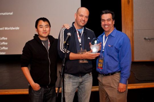 Stephane Gauger holding the trophy for Best Narrative Feature with Joe Kim and Michael Wingate-Jones